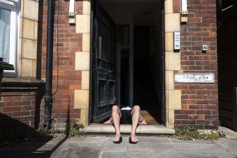 Another of Mr Waters' photos - a man enjoys some sun while stuck inside