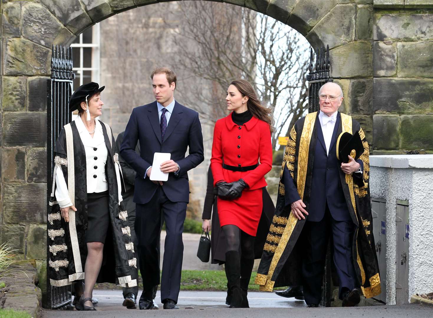 The couple pass St Salvator’s halls, accompanied by Sir Menzies Campbell (right), during a previous return visit (Andrew Milligan/PA)