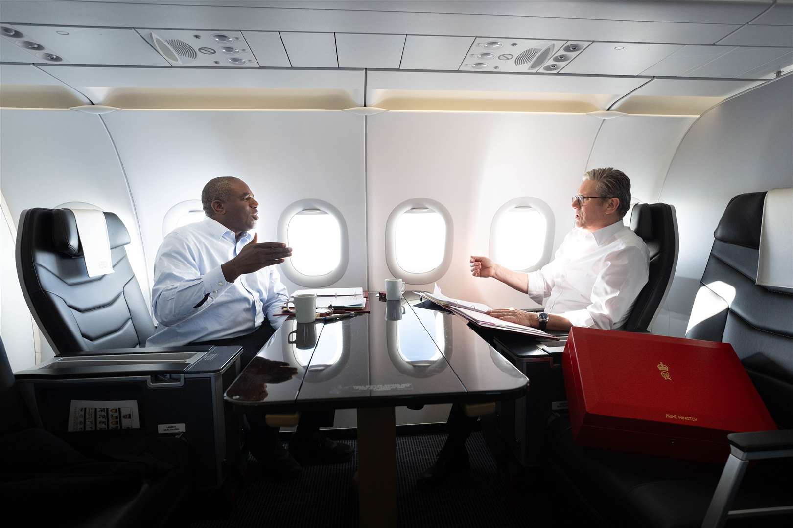 Prime Minister Sir Keir Starmer and Foreign Secretary David Lammy work on the plane as they fly to Washington DC for talks with President Joe Biden (Stefan Rousseau/PA)