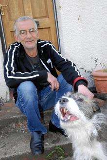 Keith Hall with his mean and hero dog, who chased away a knifeman.
