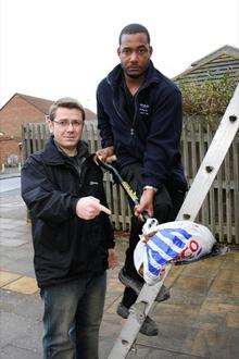 Cllr Tony Watson (Con) and Medway Council community officer Johnny Robinson with a bag of poo which was found on the roof of the public toilets in Hoo village square