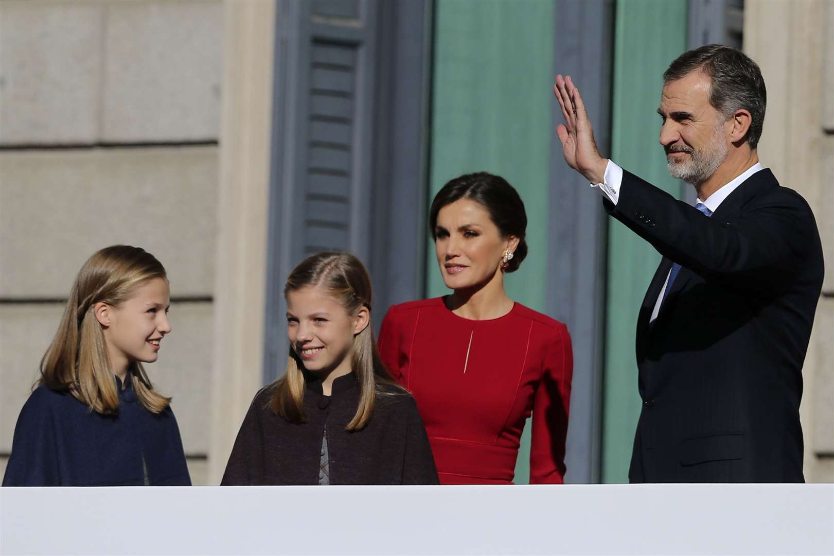 Spain’s King Felipe VI and his wife Queen Letizia wave to the crowd with their daughters Princess Leonor, left, and Princess Sofia (Andrea Comas/AP)