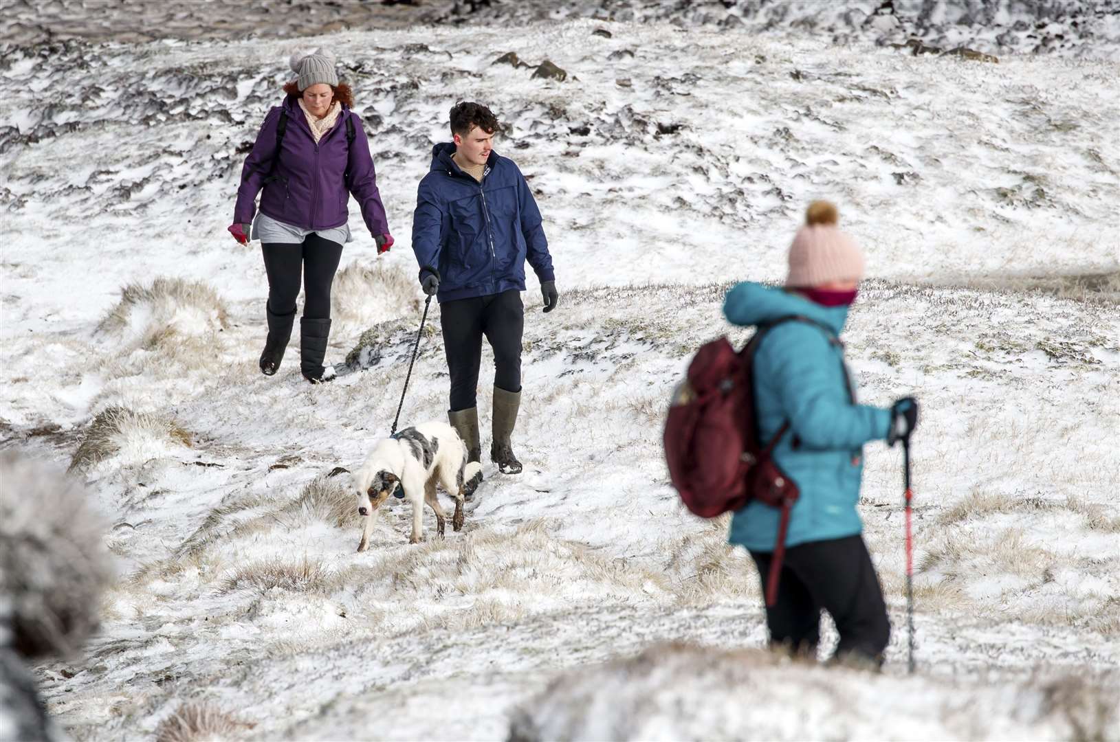 Hikers in snow on Bleaklow Moor in the Peak District (Danny Lawson/PA)