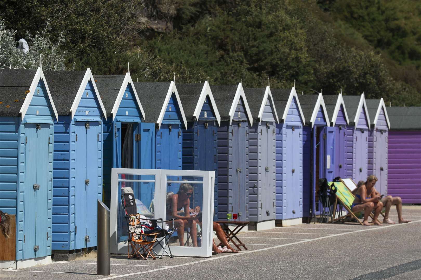 People use their beach huts at Bournemouth as the hot weather continues (Steve Parsons/PA)