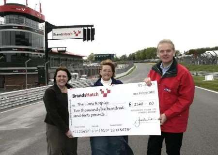 Chief executive at Brands, Jonathan Palmer, with members of the Lions hospice