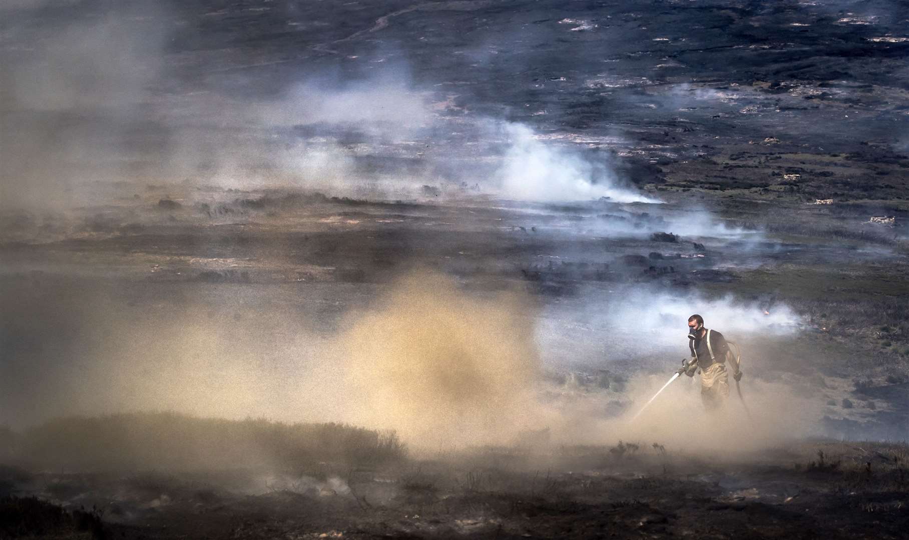 Firefighters tackling the wildfire on Saddleworth Moor in 2018 (Danny Lawson/PA)