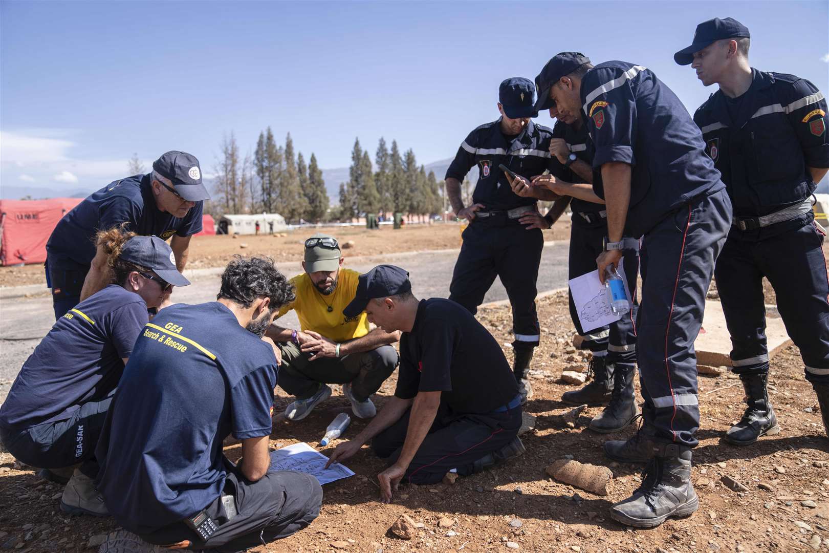 Moroccan and Spanish emergency units discuss plans at a military camp in the town of Amizmiz, near Marrakesh (Mosa’ab Elshamy/AP)