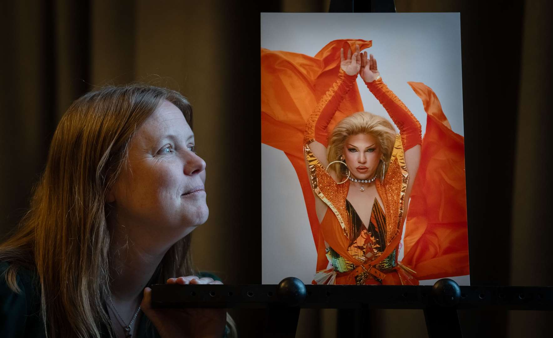 Vicky Robayna with photographs of a cast member of RuPaul’s Drag Race UK, taken by her daughter (Danny Lawson/PA)