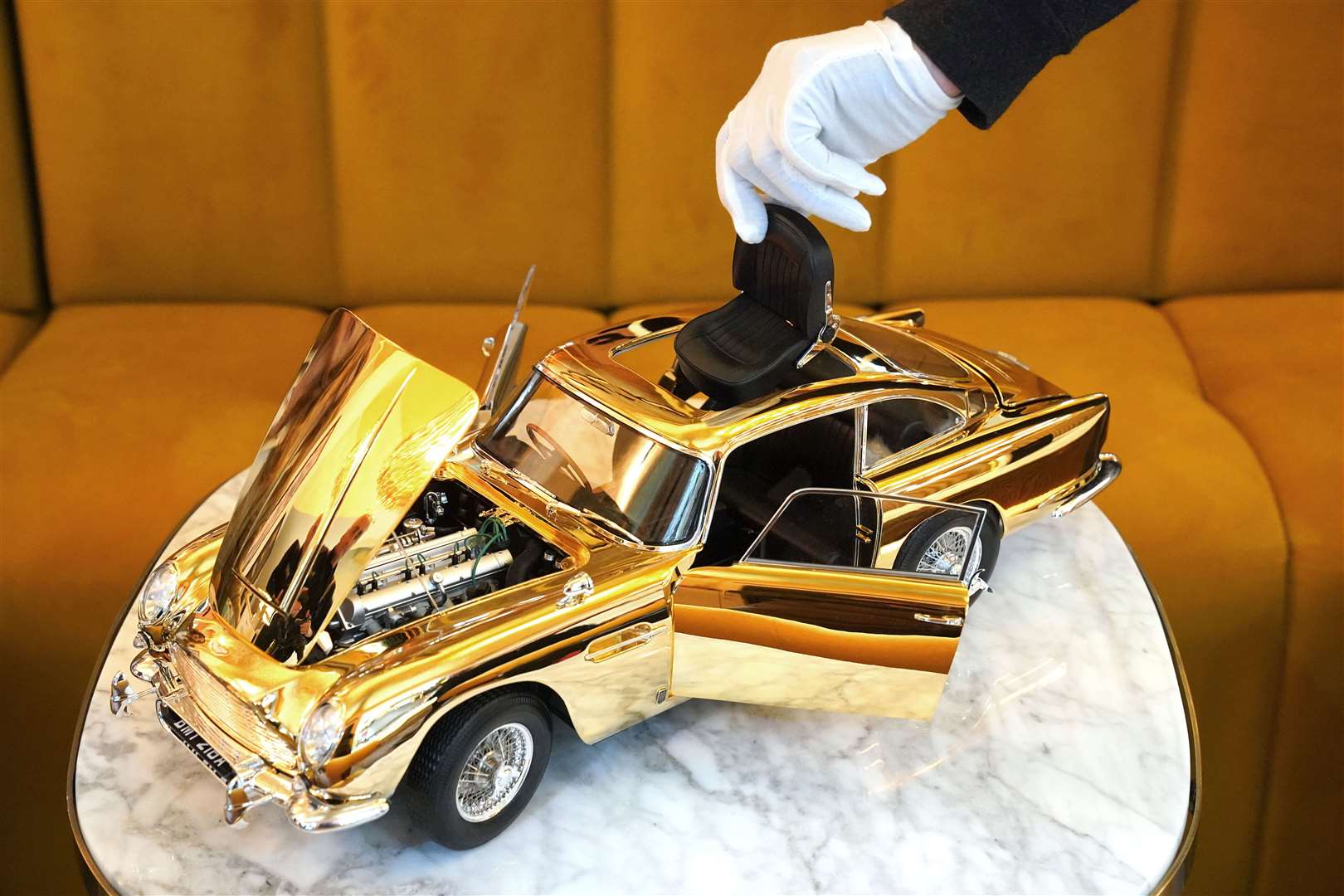 The ejector seat on a 24-carat gold-plated model of James Bond’s Goldfinger Aston Martin DB5 (Jonathan Brady/PA)