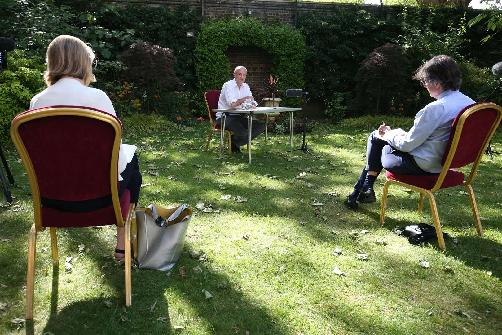 Journalists sit at a distance while asking questions (Jonathan Brady/PA)