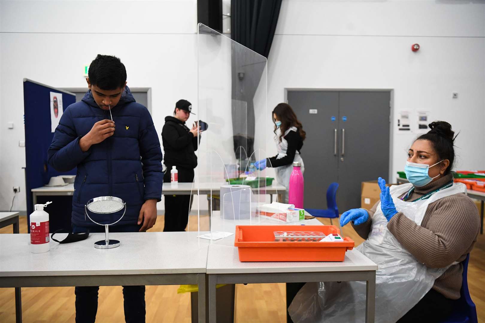 A student takes a lateral flow test at Hounslow Kingsley Academy in West London (PA)