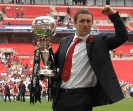 Triumphant manager Liam Daish shows off the FA Trophy to the Fleet fans. Picture: Barry Goodwin