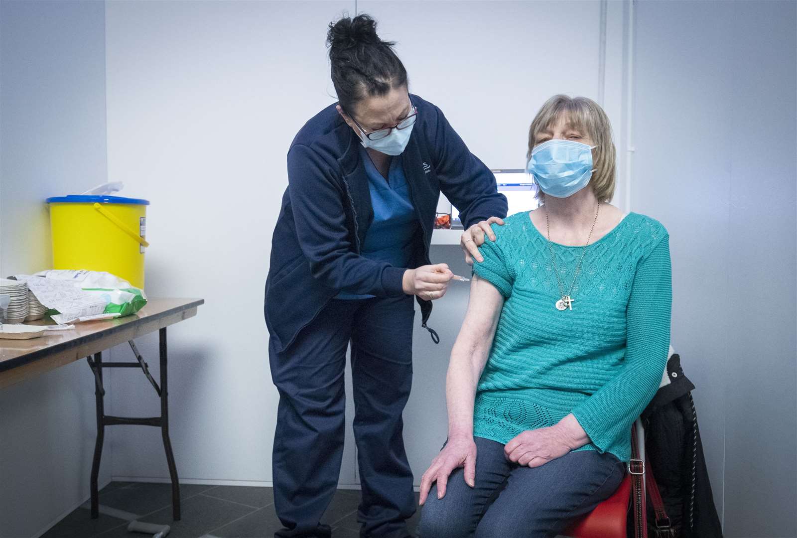Sarah MacLeod gives Margaret Swift her vaccine in Edinburgh (Jane Barlow/PA)