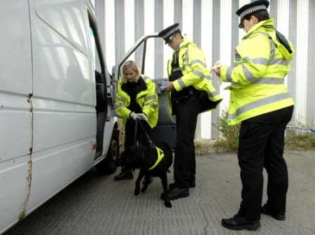 Police examine one of the vehicles stopped. Picture: MATTHEW WALKER