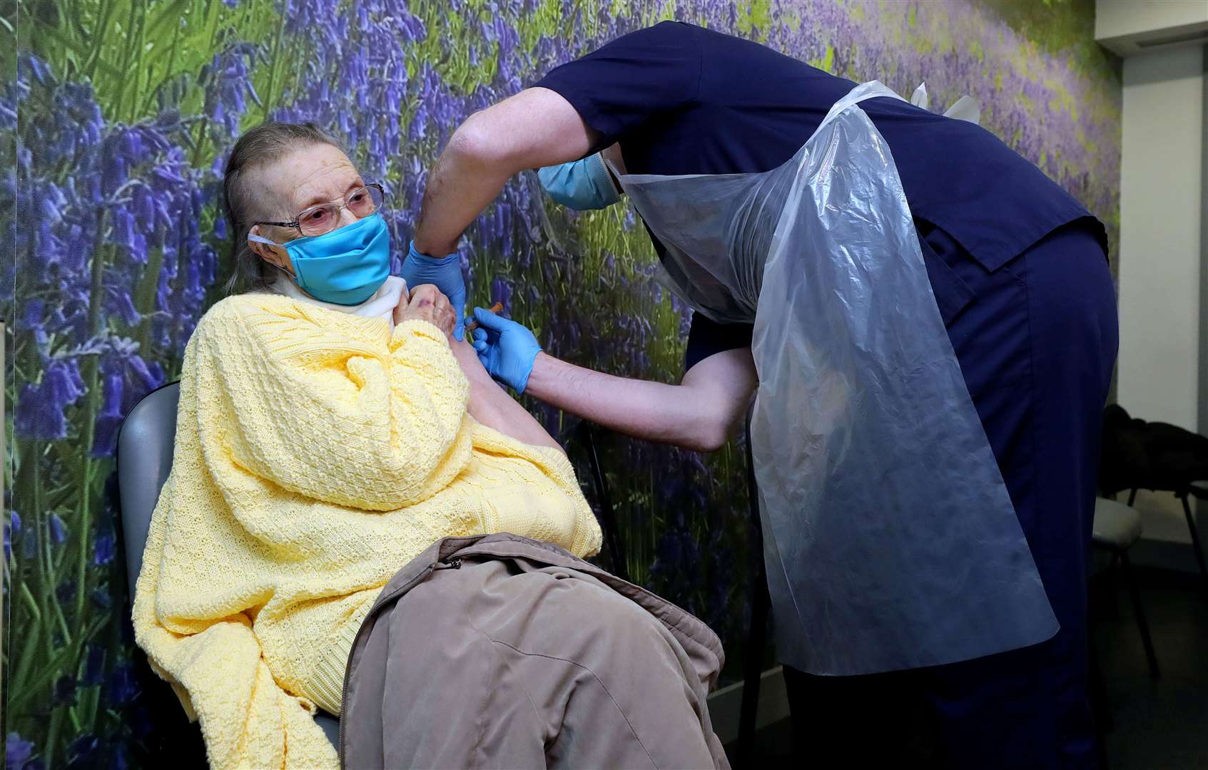 Eileen Lynch, 94, receives the first of two doses of the Oxford/AstraZeneca Covid-19 vaccine in Belfast (Liam McBurney/PA)