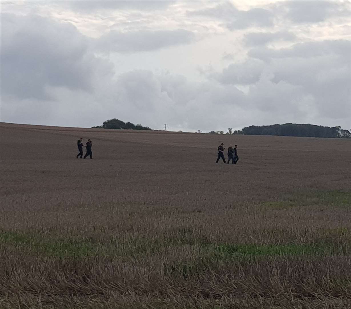 Officers return with their suspects. Photo: Phil Ward