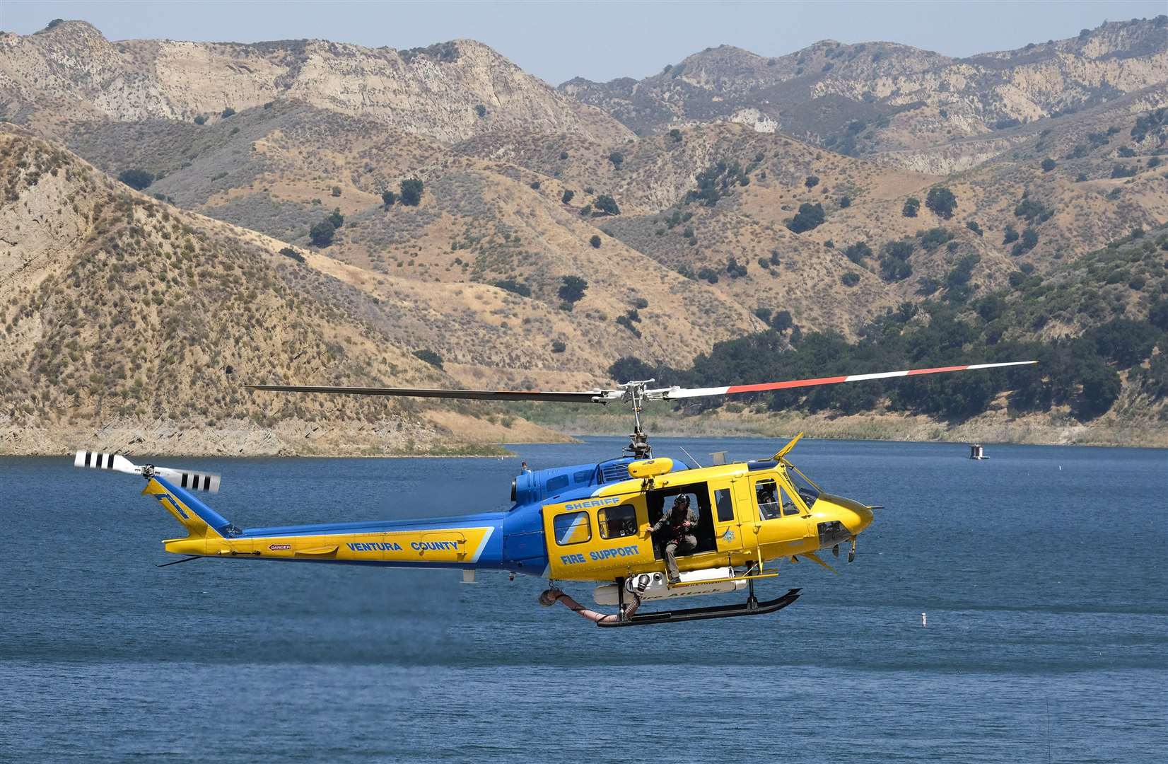 A Ventura County sheriff’s helicopter scoured the surface of Lake Piru (AP Photo/Ringo H.W. Chiu)