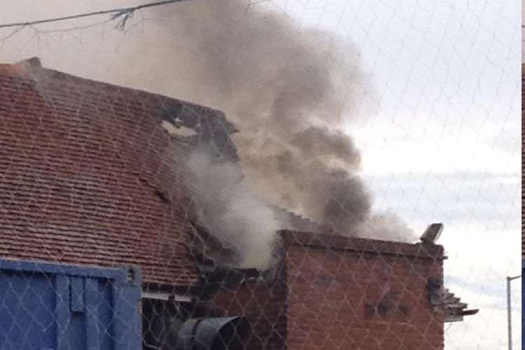 Smoke billows from the badly-damaged roof of The Holly Tree