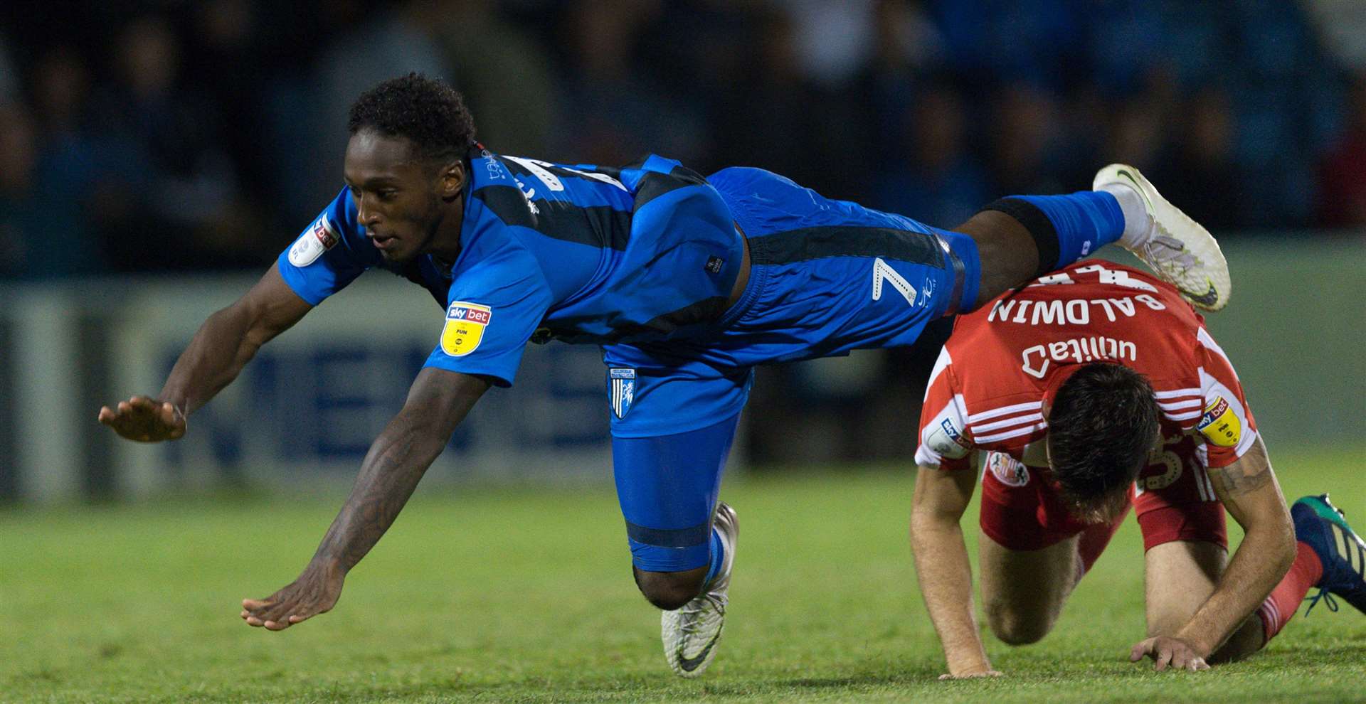 Gillingham's Brandon Hanlan goes down under a challenge from Jack Baldwin. Picture: Ady Kerry