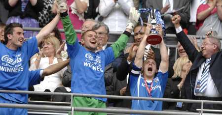 Barry Fuller gets the celebrations under way by lifting the League 2 play-off Trophy