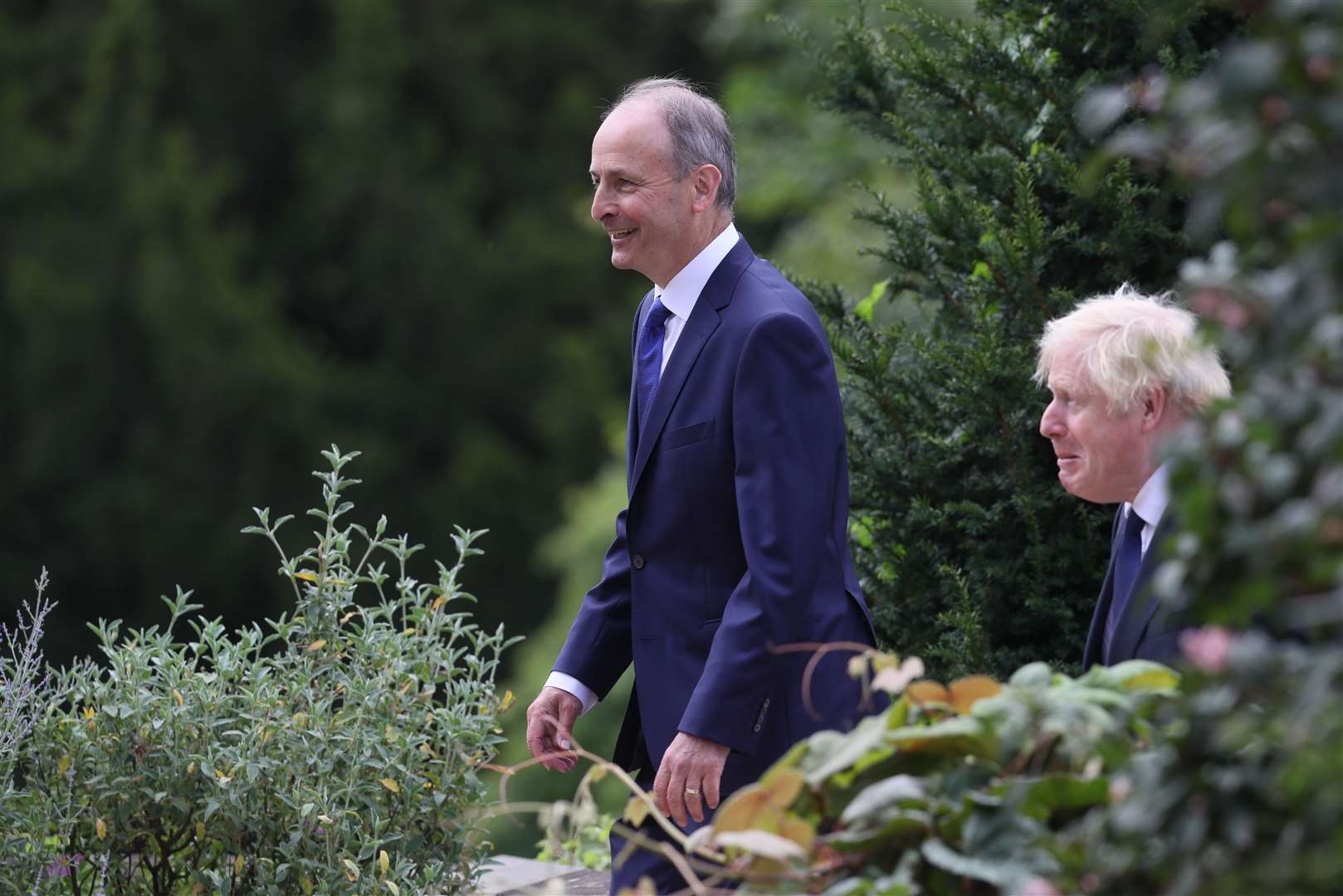 Prime Minister Boris Johnson (right) and Taoiseach Micheal Martin walking in the gardens at Hillsborough Castle (Brian Lawless/PA)