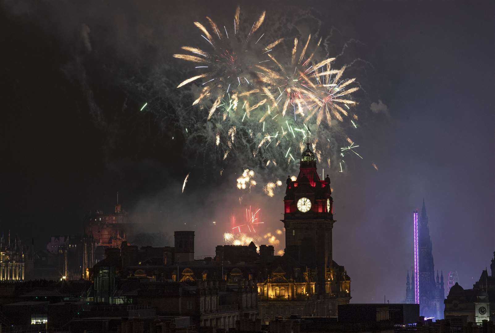 Fireworks are launched from Edinburgh Castle at midnight during the Hogmanay New Year celebrations (Jane Barlow/PA)