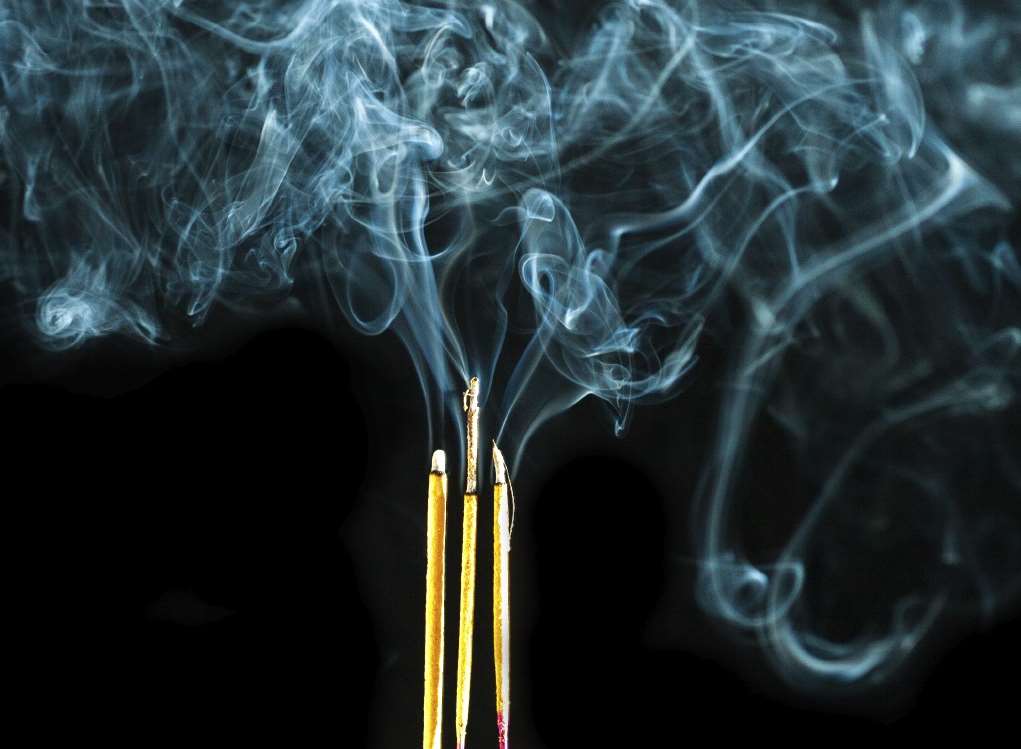 The burning incense sticks were left unattended. Stock image.