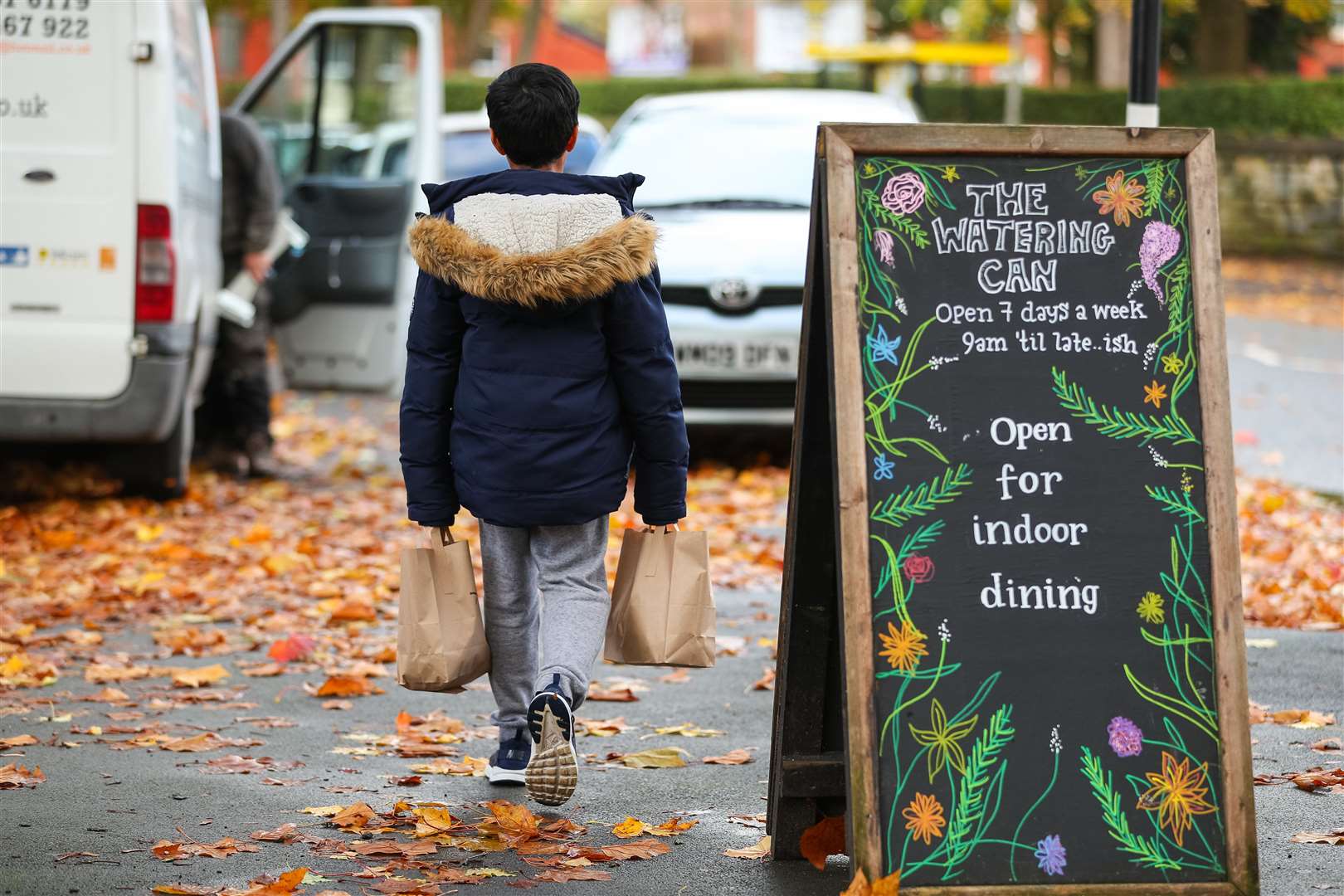 A child collects lunch bags (Peter Byrne/PA)