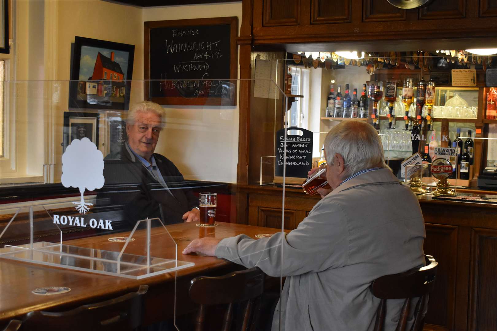 Customers at the Royal Oak enjoy a pint (Matthew Cooper/PA)