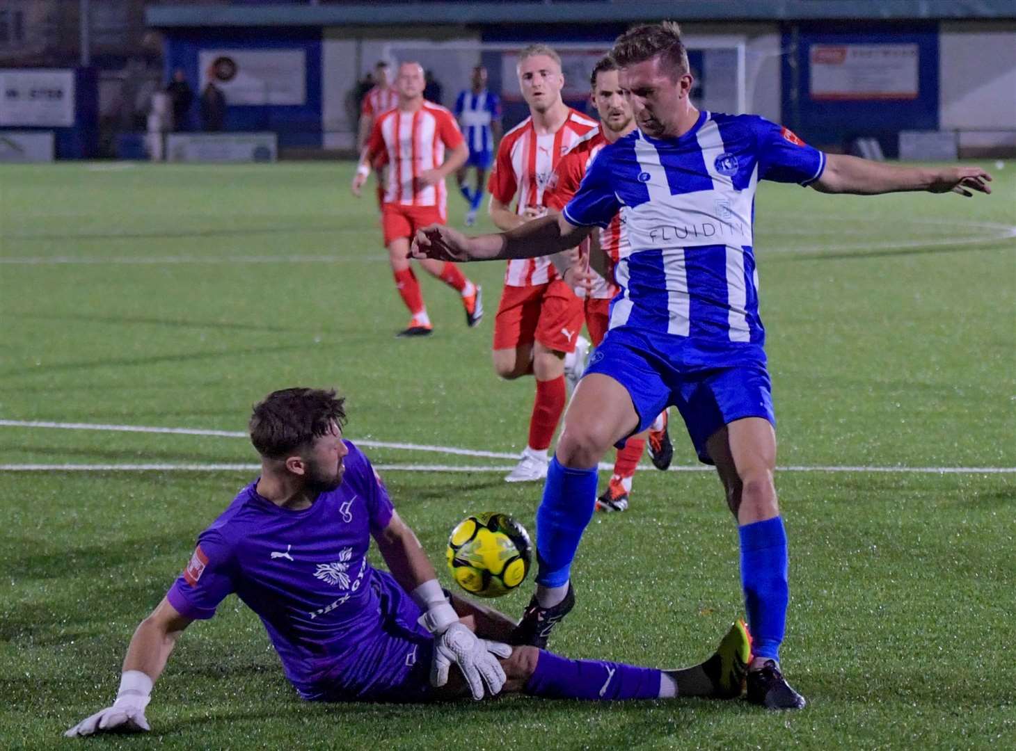 Herne Bay's Kane Rowland battles for the ball with away goalkeeper Nathan Stroomberg-Clarke in midweek. Picture: Stuart Watson