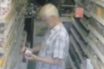 As the man looks at a product, a box of tea bags appears to levitate from a shelf behind him