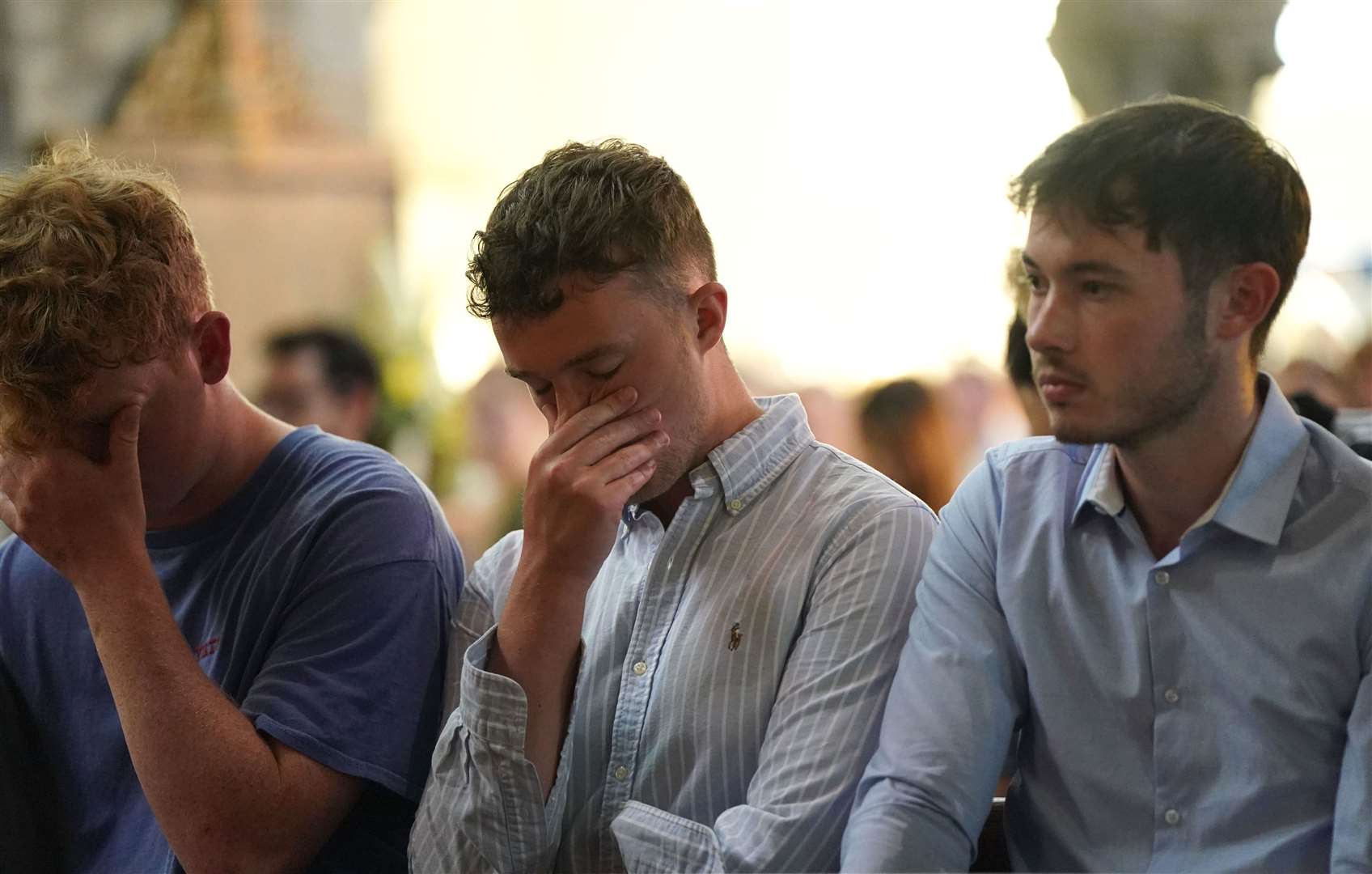 People at a vigil at St Peter’s church (Jacob King/PA)