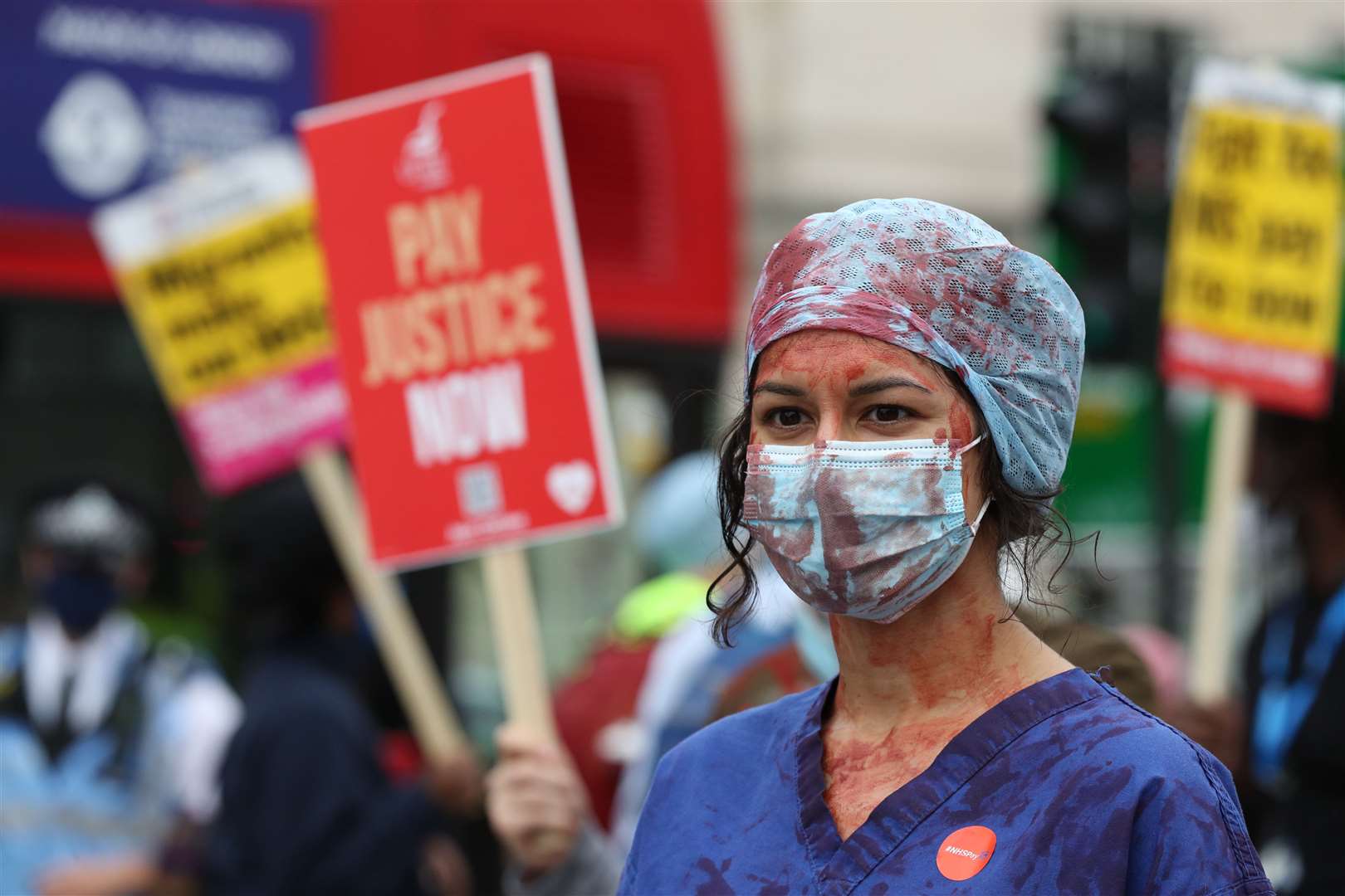 An NHS worker at a rally at St Thomas’ Hospital, London (Jonathan Brady/PA)