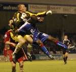 Jamie Ashdown punches clear ahead of Darren Byfield. Picture: ANDY PAYTON