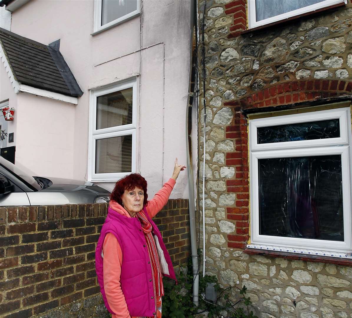 Shelley Morgan shows the visible smoke damage outside her home