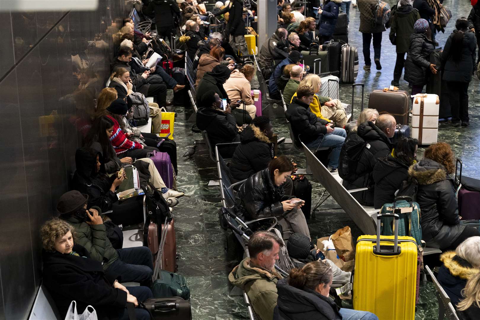 Passengers at Euston station, London, following train delays as Storm Isha has brought severe disruption to rail services (Jordan Pettitt/PA)