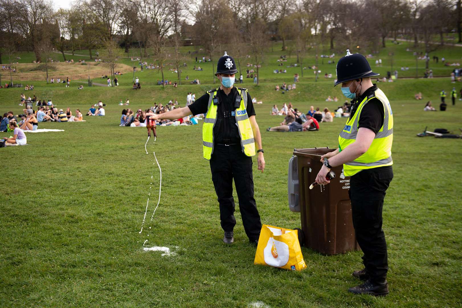 Police officers confiscate and dispose of alcohol at the Forest Recreation Ground (Jacob King/PA)