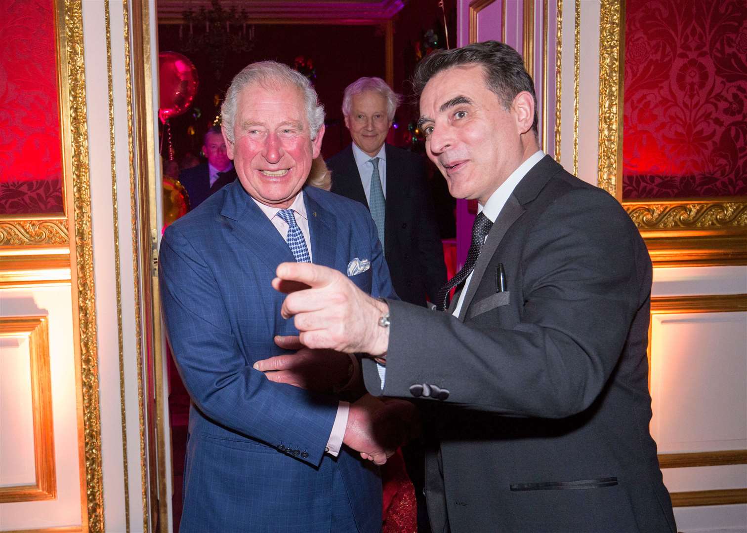 Etienne Pradier meets Prince Charles at the royal's Christmas party. Picture: Ian Jones