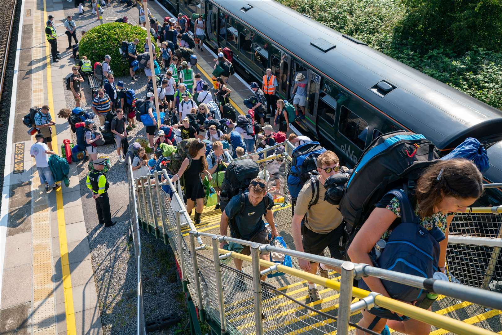 Meanwhile, in Somerset, revellers made their way out of Castle Cary train station and onto buses to shuttle them to the Glastonbury Festival site (Ben Birchall/PA)