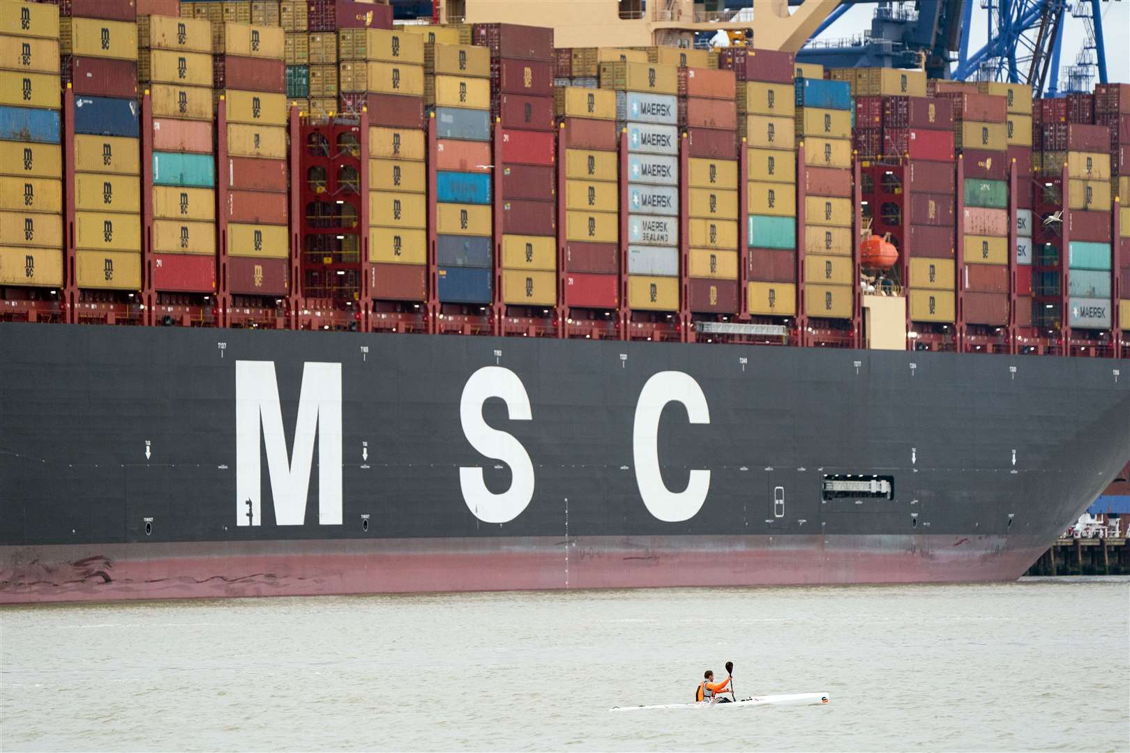 A man in a kayak is dwarfed by MSC Loreto (Joe Giddens/PA)