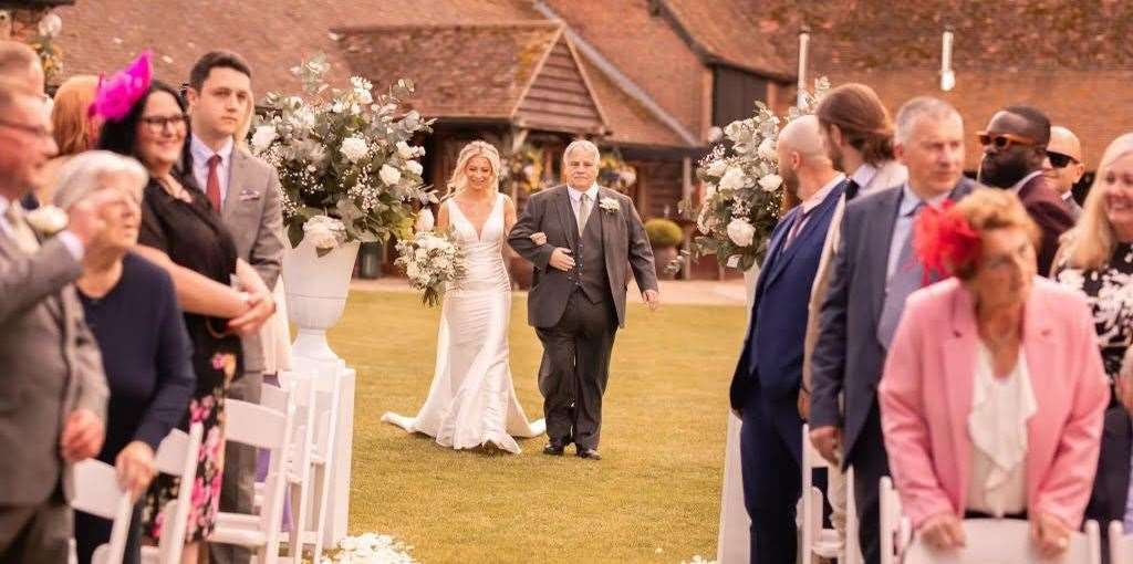 Ron walking his daughter down the aisle