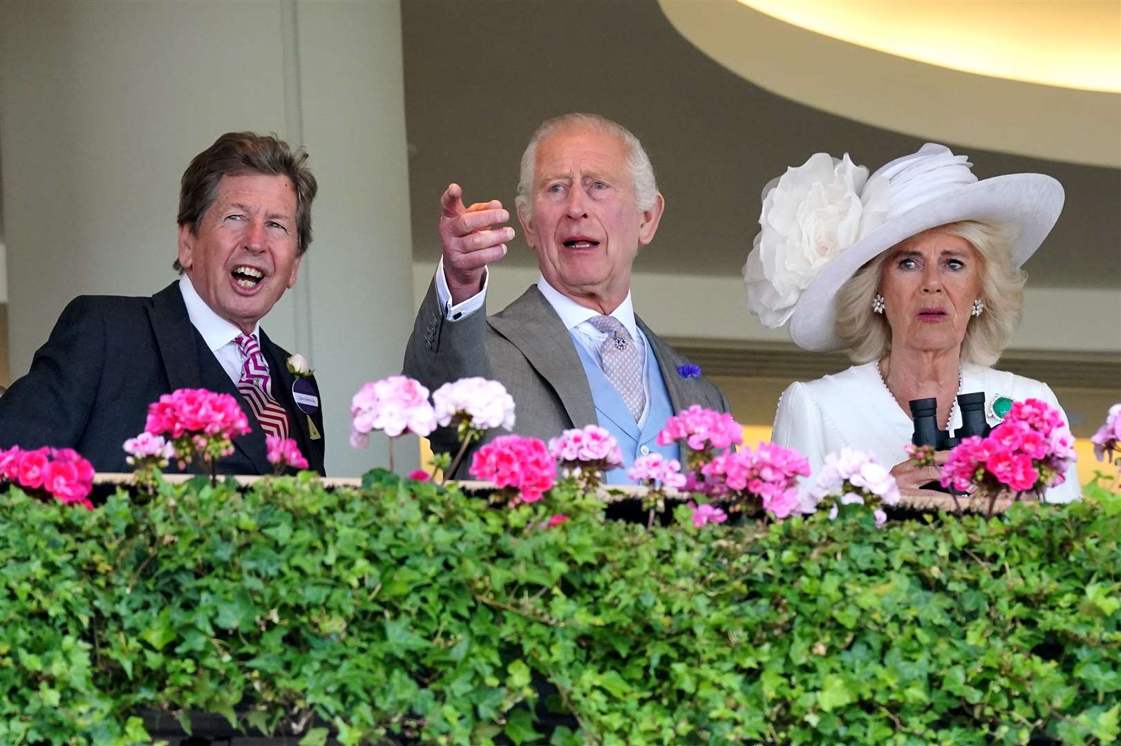 The King, Queen (right) and racing adviser John Warren react during the King George V Stakes (Jonathan Brady/PA)