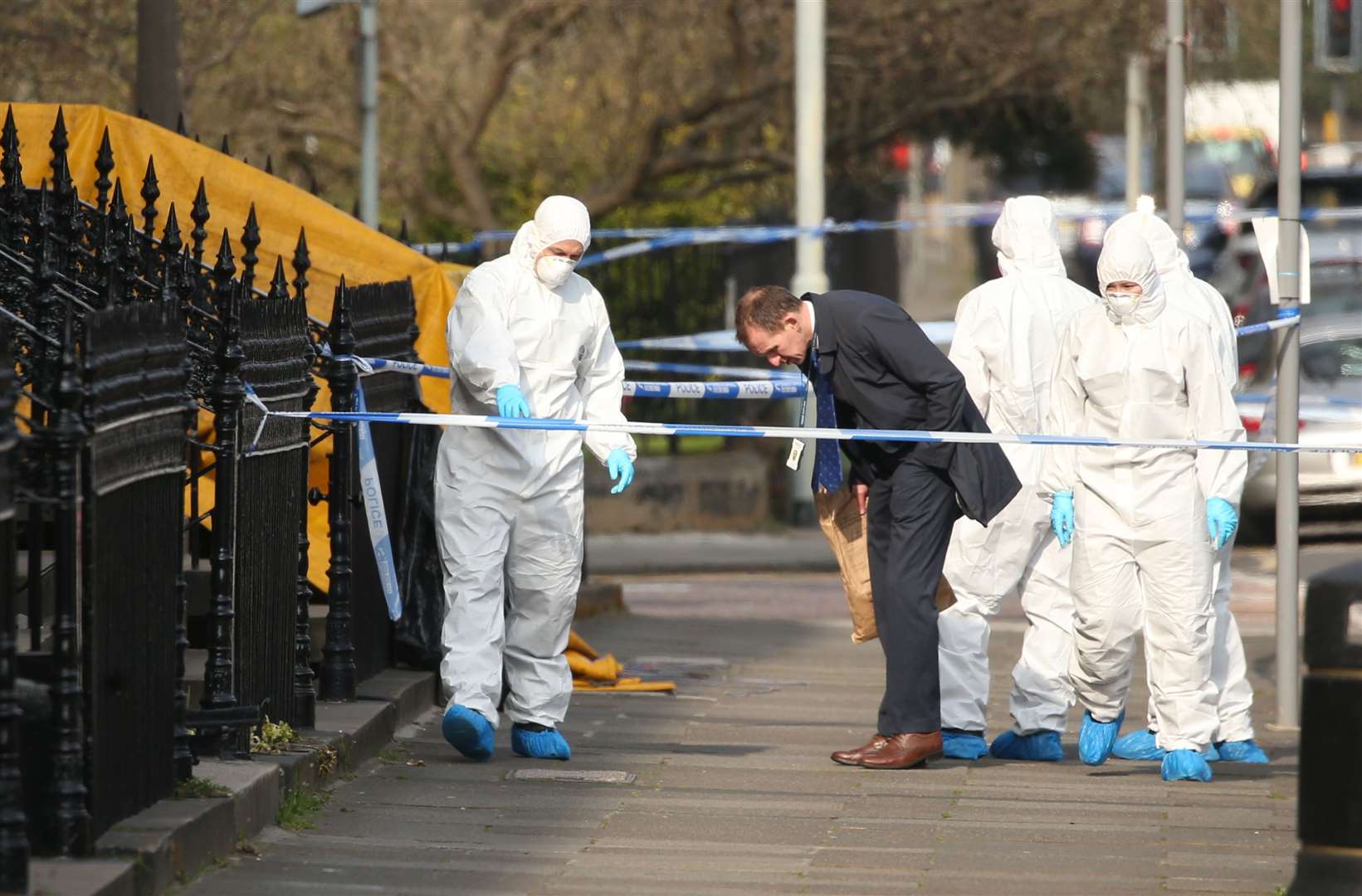 Police and forensics experts at the scene of Mr Welsh’s murder in Edinburgh’s west end (PA)