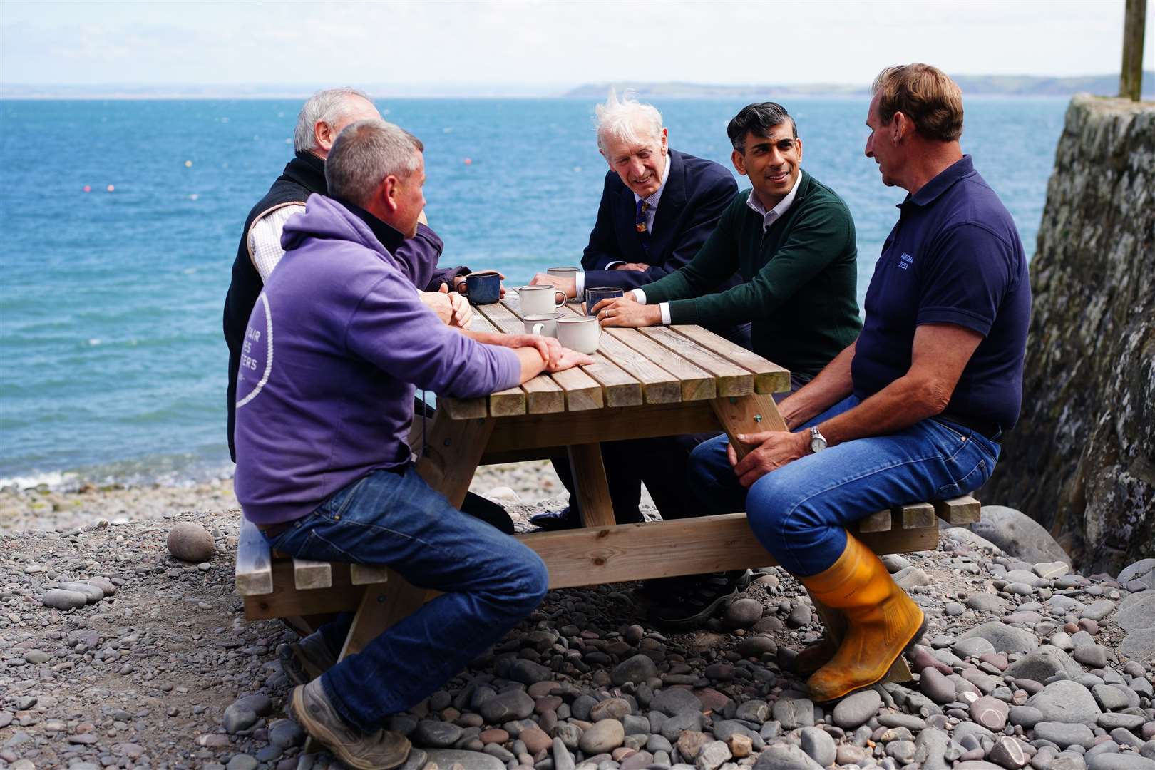 Prime Minister Rishi Sunak speaks to fishermen during a visit to the Red Lion Hotel, Bideford in north Devon (Ben Birchall/PA)