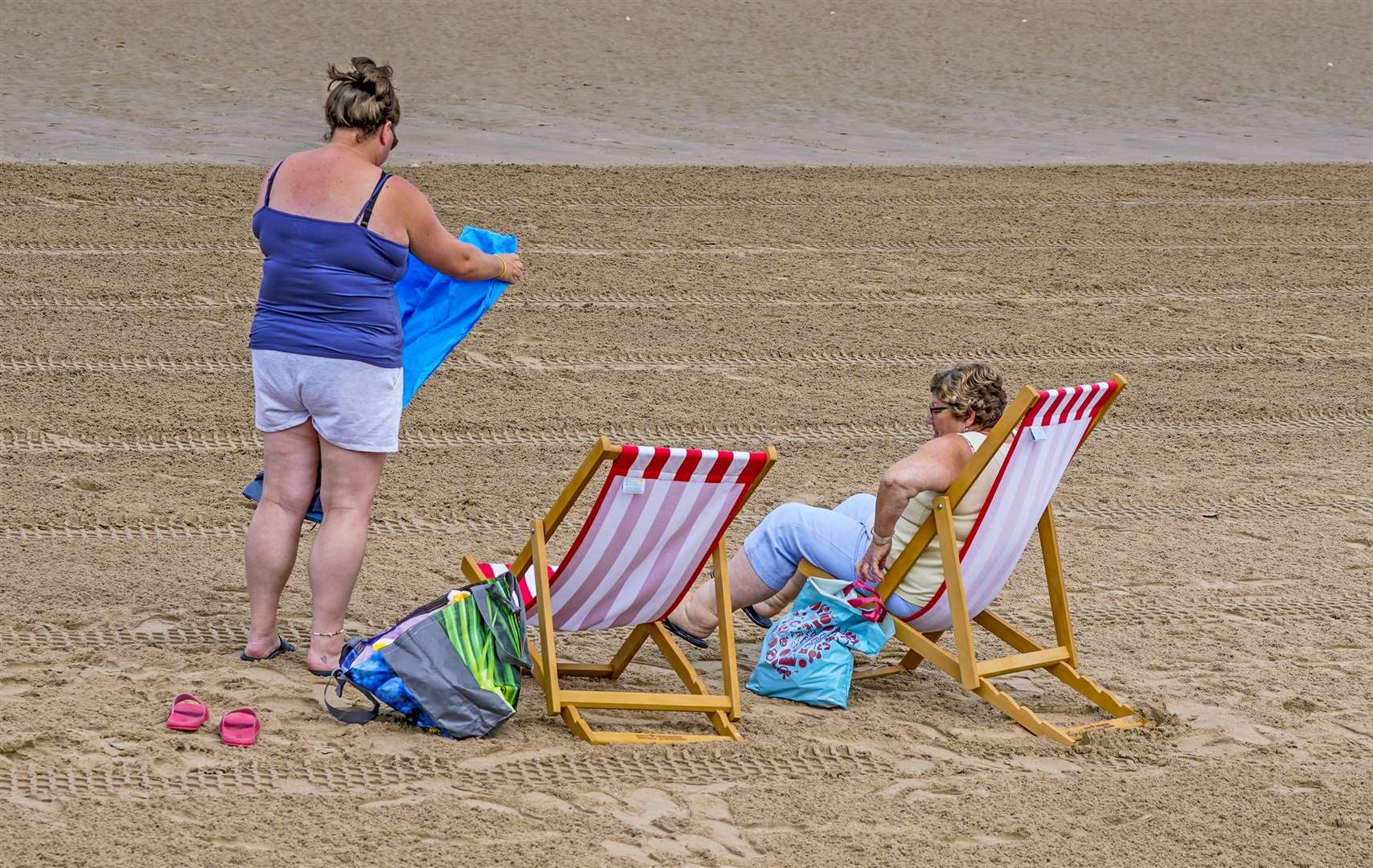 Two women use some of the new deckchairs (Peter Byrne/PA)