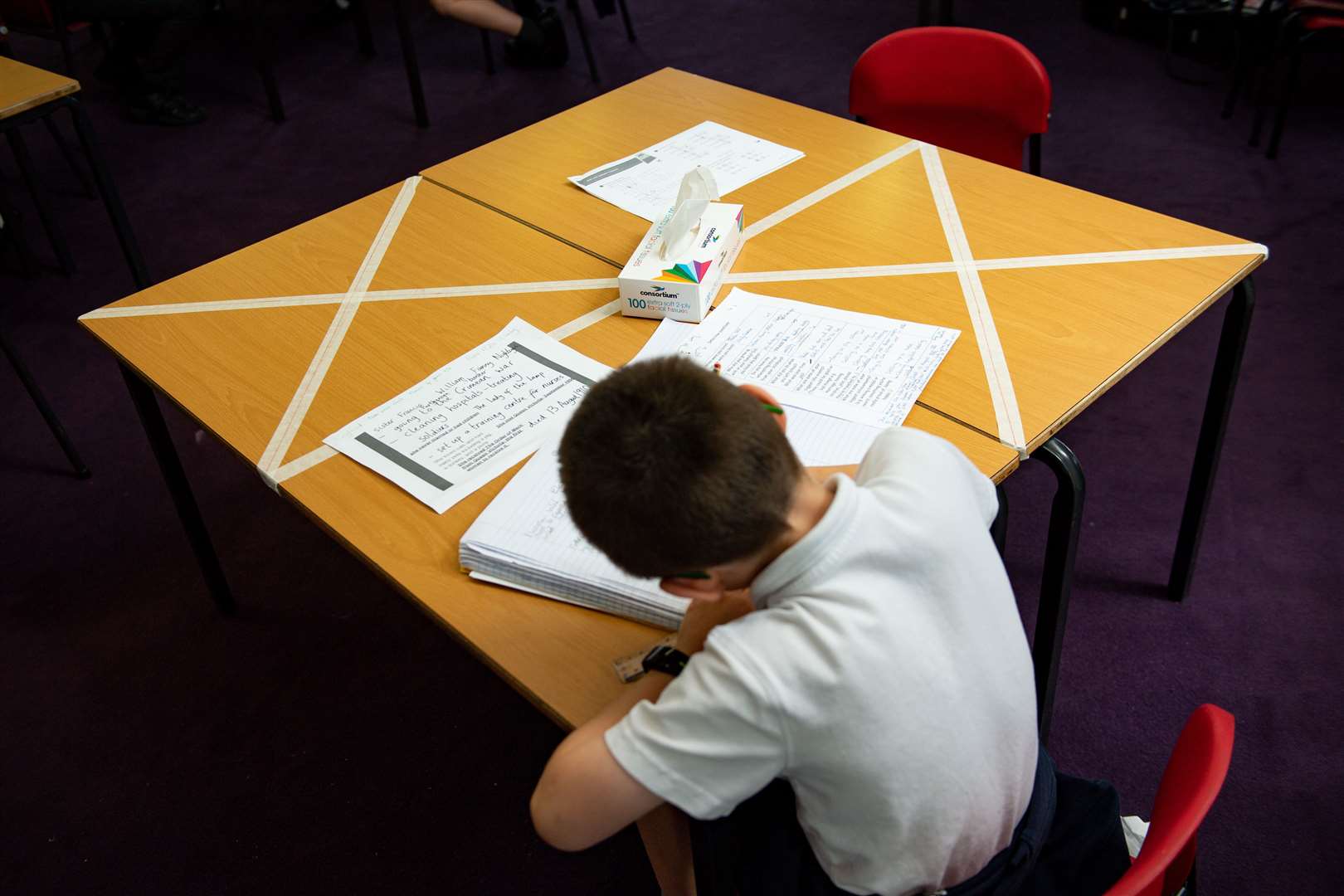 Social-distancing measures as a child studies on a marked table at Kempsey Primary School in Worcester. Nursery and primary pupils could return to classes from June 1 following the announcement of plans for a phased reopening of schools (Jacob King/PA)