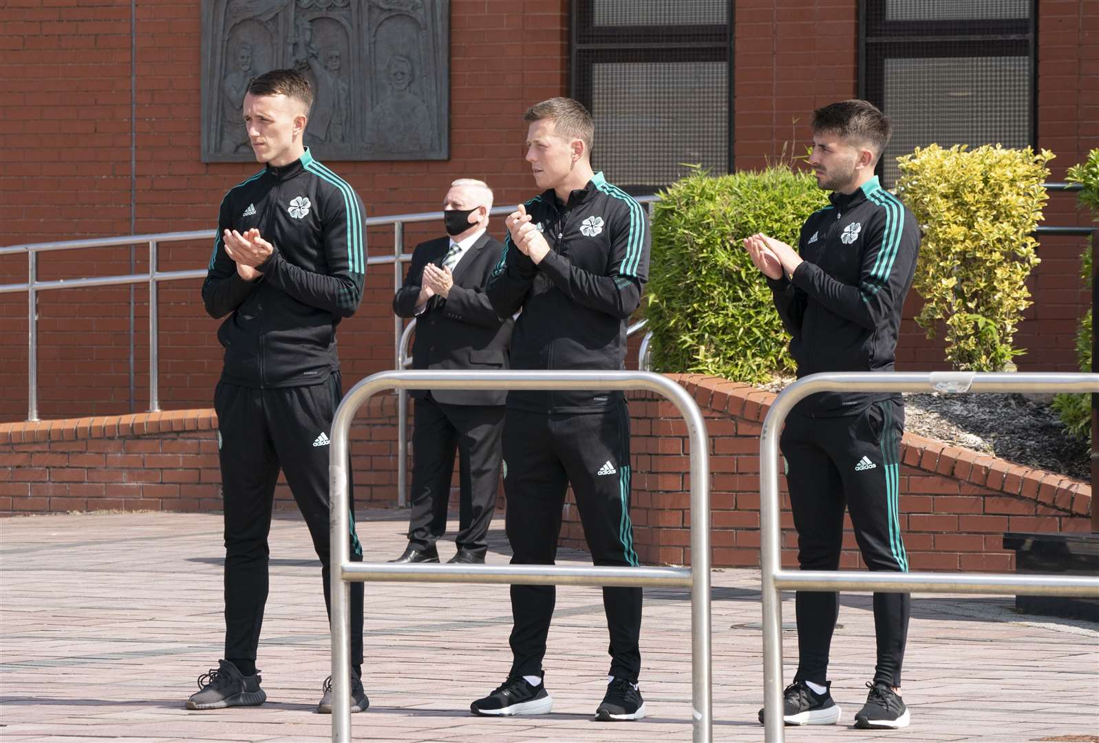 David Turnbull, club captain Callum McGregor and Greg Taylor clapped as the funeral procession passed Celtic Park (Jane Barlow/PA)