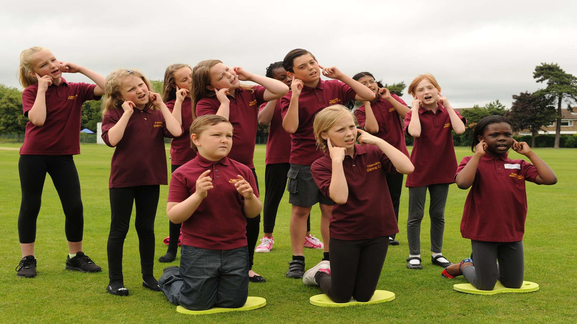 A choir sings and signs