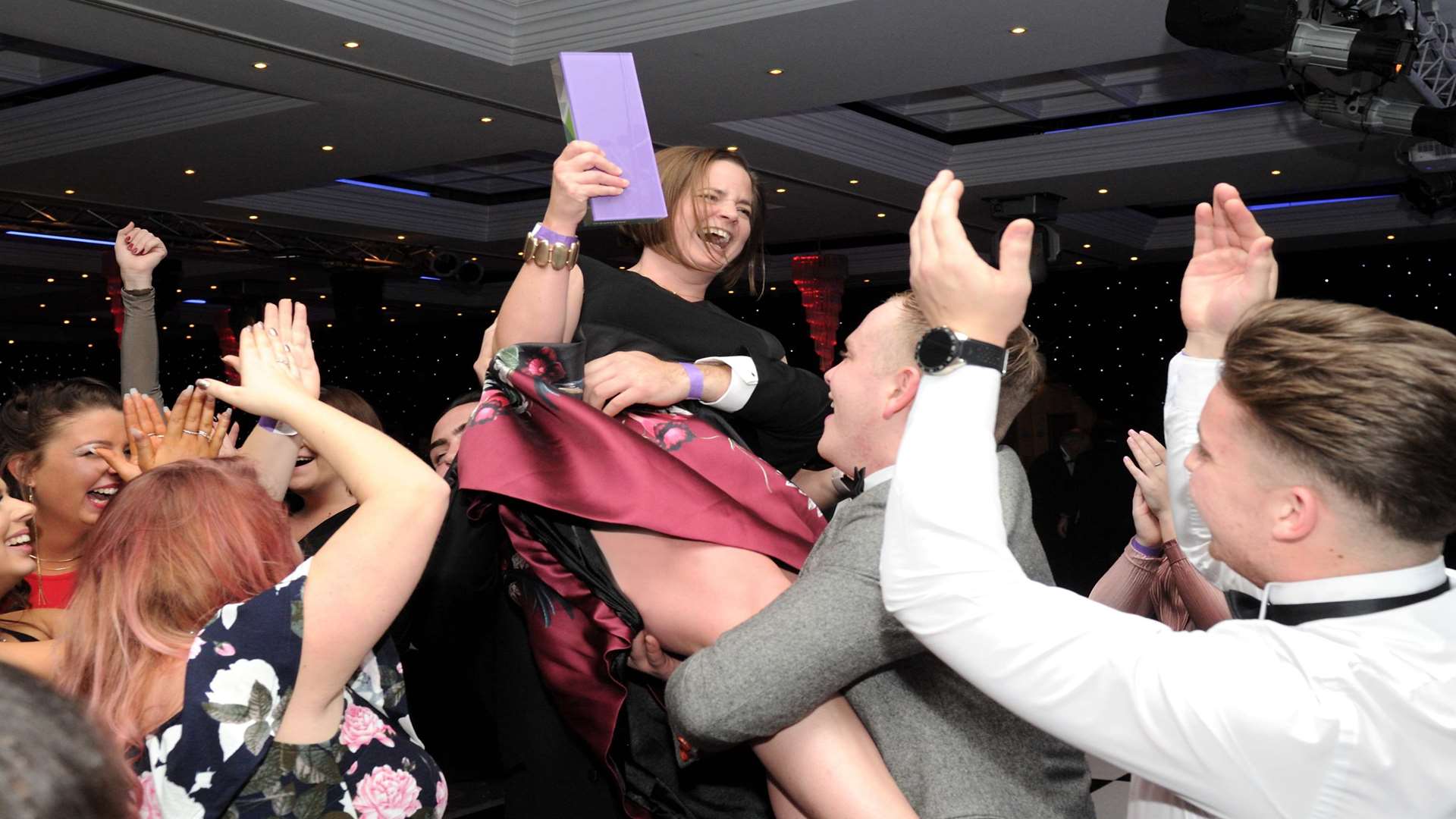 General manager Rebecca Collins is hoisted into the air by her team at Cooling Castle Barn after winning at the Medway Business Awards. Picture: Simon Hildrew