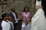 Bishop John Hine chats with Ben and Mary Kuevidjen, who have been married for 10 years, and their children Sena, seven and Seyram, nine